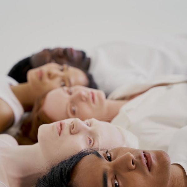 A diverse group of people meditating together, showing inclusivity.